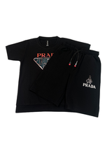 Black boys' matching coordinate set, including a short-sleeve T-shirt with a large metallic triangle logo and black shorts with a white logo graphic and drawstring