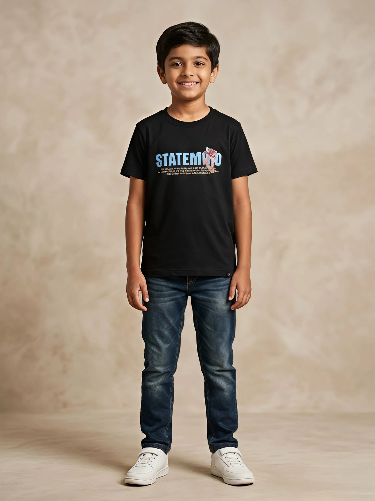A young boy wearing a black short-sleeve crew neck t-shirt with a blue and red graphic print reading 'STATEMENT' on the front, paired with blue jeans and white sneakers as seen in the file 8231-BLACK-RED SOUND-artguru.jpg.