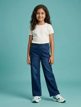 Young girl wearing stylish navy blue elastic waist casual pants paired with a plain white t-shirt and white sneakers.