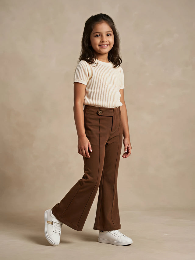 Young girl wearing brown high-waist flared casual pants with front seam detailing and white sneakers