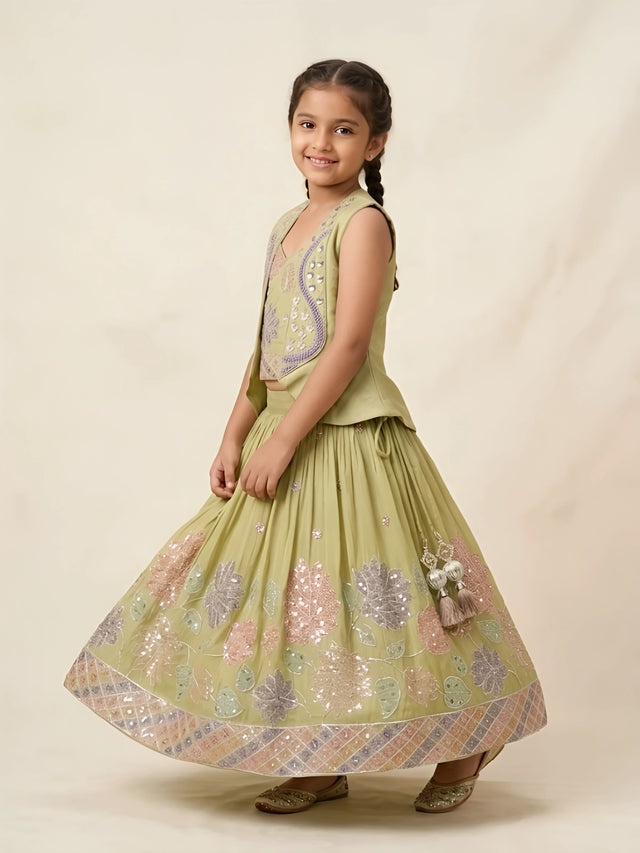 Girls wearing a green floral embellished lehenga choli set with a jacket overlay and tassel details.