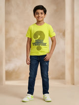 Boys wearing a neon green short sleeve graphic t-shirt with a question mark print paired with dark blue jeans