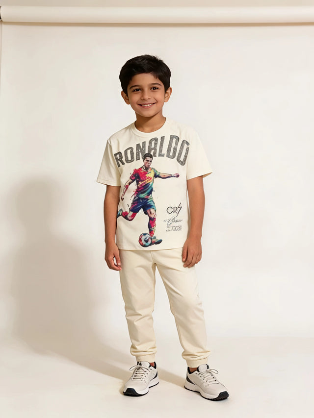 Young boy wearing a cream short-sleeve round-neck t-shirt with a colorful Ronaldo football graphic print