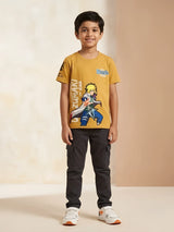 Young boy wearing a mustard yellow round-neck graphic printed anime t-shirt with short sleeves.
