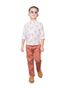 Young boy posing in a white shirt with a rust-colored cactus print and rust/terracotta straight-fit trousers, paired with brown casual slip-on shoes and sunglasses