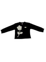 Girls' long-sleeved black top with a large, sparkly flower appliqué made of rhinestones or pearls on the chest.

Export to Sheets