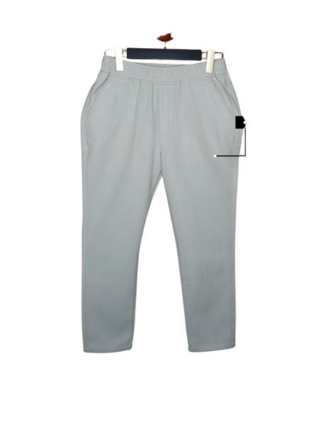 Boys' slate green/light khaki colored slim-fit casual trousers with an elastic waistband and side pockets, displayed on a hanger.