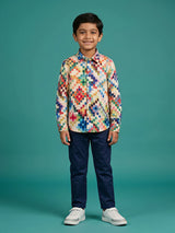 Young boy wearing a multicolor pixel grid print full-sleeve casual shirt with navy blue trousers