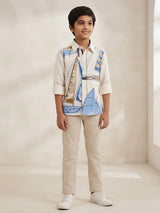 Boys wearing a cream full sleeve casual shirt featuring a sailboat print and button-down front