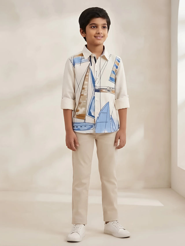 Boys wearing a cream full sleeve casual shirt featuring a sailboat print and button-down front