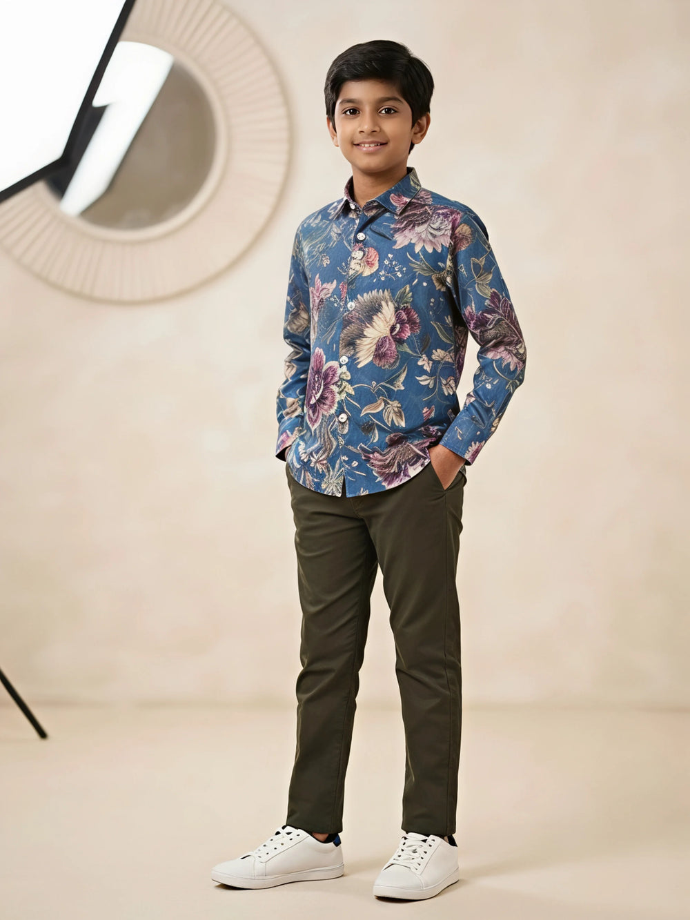 Boys wearing a blue full sleeve casual shirt with an all-over floral print paired with trousers