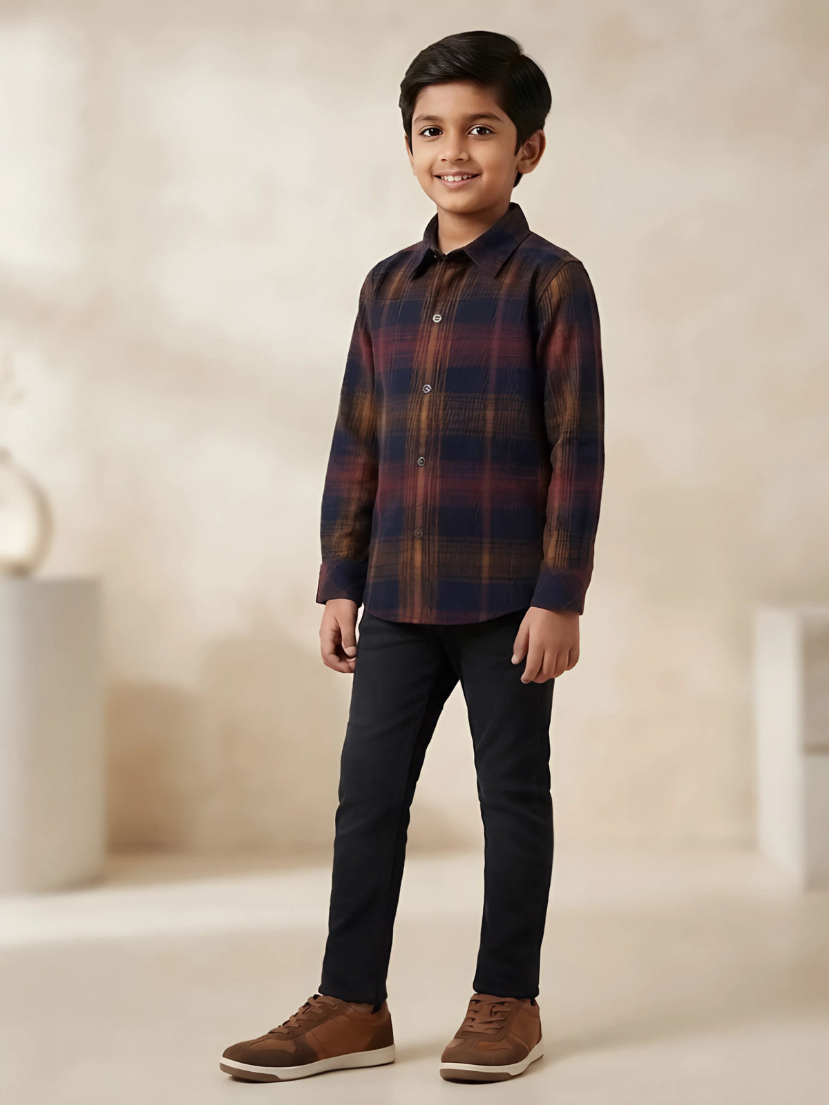 Boys wearing a brown and navy plaid full sleeve casual shirt with black trousers