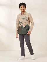 Boys wearing a cream full sleeve casual shirt with a bird print motif and button-front collar.
