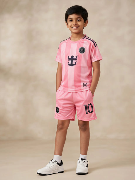 Young boy wearing a stylish peach sports coordinate set with a striped short-sleeve t-shirt and matching shorts with pockets.