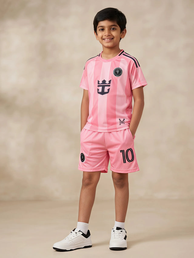 Young boy wearing a stylish peach sports coordinate set with a striped short-sleeve t-shirt and matching shorts with pockets.