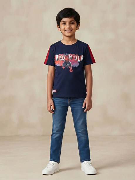 Young boy wearing a navy blue round neck t-shirt with Marvel Red Hulk chest print and red sleeve panels.