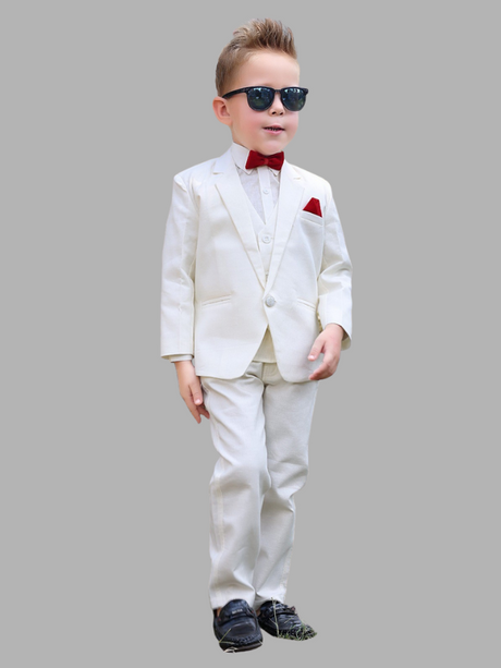 Full-length image of a young boy wearing a three-piece white/cream formal suit with a red bow tie and pocket square, along with sunglasses and black shoes.