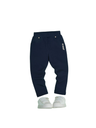 Pair of solid navy blue girls' casual pants/jeggings with an elastic waistband, small gold stud details, and a white vertical logo embroidery on the hip, displayed with white sneakers