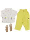 Girls' two-piece set featuring a white short-sleeve collared shirt with colorful floral embroidery, paired with bright neon lime green cargo pants with an elastic waist, and gold glitter Mary Jane shoes.