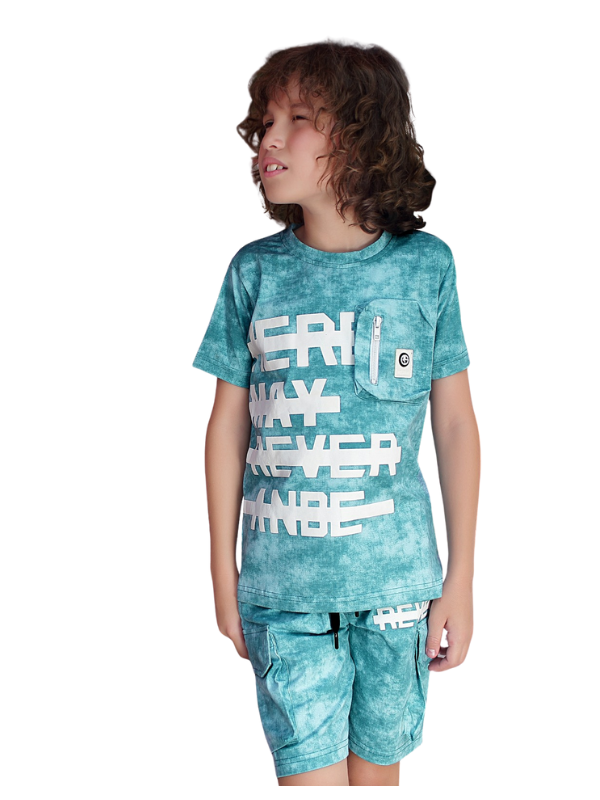 Young boy with curly hair wearing a teal/blue tie-dye T-shirt with a bold white graphic print and a zipper pocket, matched with tie-dye cargo shorts for a casual summer look.
