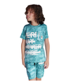 Young boy with curly hair wearing a teal/blue tie-dye T-shirt with a bold white graphic print and a zipper pocket, matched with tie-dye cargo shorts for a casual summer look.