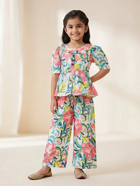 Young girl wearing a bright multicolor floral print peplum top and matching wide-leg plazo pant set