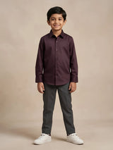 Young boy wearing a solid dark purple full sleeve casual shirt paired with trousers