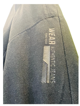 Boys' plain black denim jeans in a straight-leg style, featuring a gathered elastic waistband and a black web belt with a gold rectangular buckle.

Export to Sheets