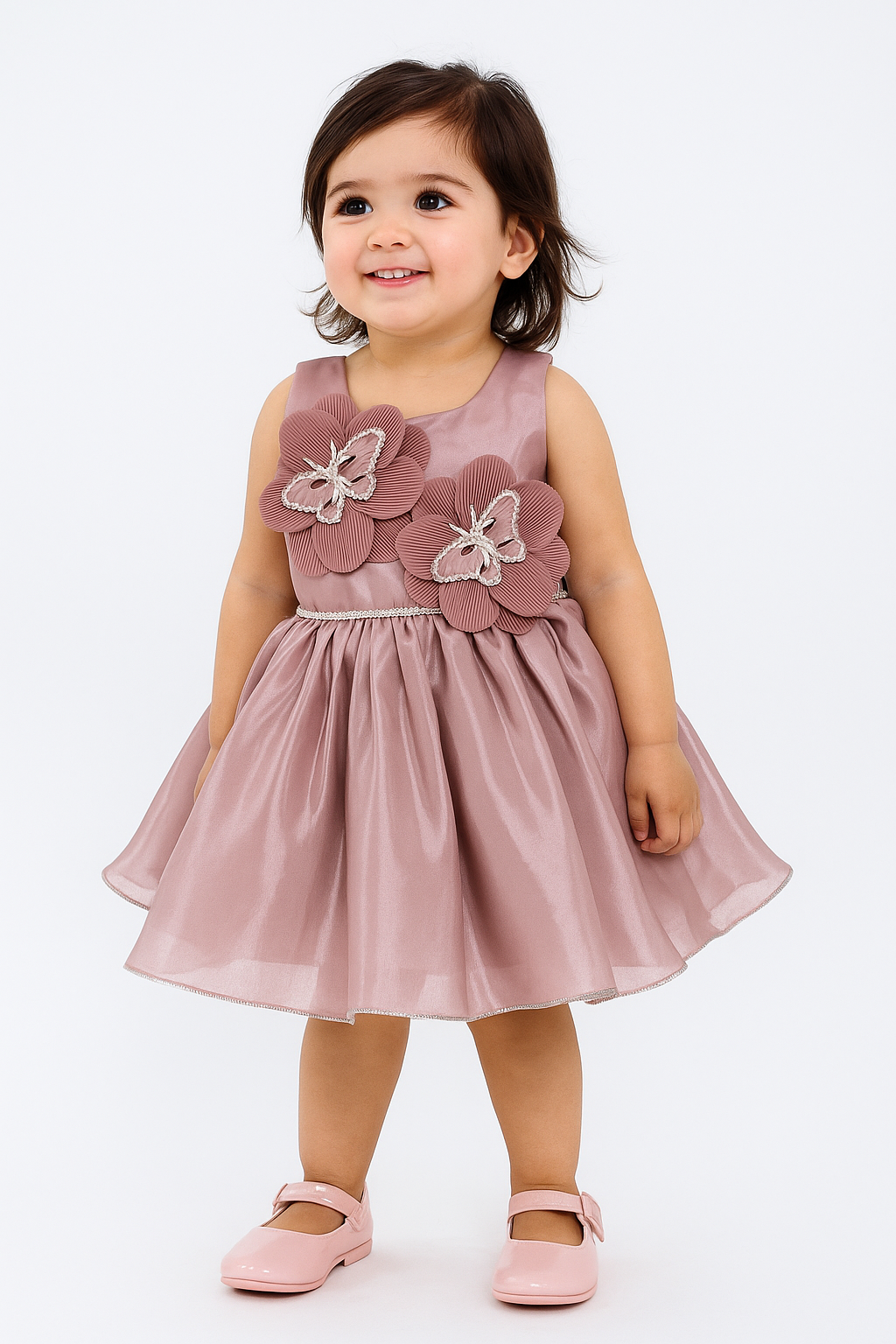 Toddler girl wearing an elegant dusty rose/peach sleeveless dress with large 3D flowers with silver accents on the chest, a shimmery skirt, and pink shoes.

Export to Sheets