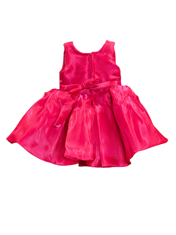 Girls' vibrant rani pink sleeveless dress with a shiny finish, featuring a large, central 3D rosette detail on the bodice and a full, flared skirt.

Export to Sheets