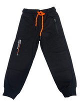 A pair of boys' black fleece jogger track pants with an elastic waist, orange and black contrast drawstring, ribbed ankle cuffs, and a vertical zippered pocket.