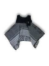 Black and white patterned girls' handkerchief hem frock with a black velvet-look bow and pearl trim on a white background.

Export to Sheets