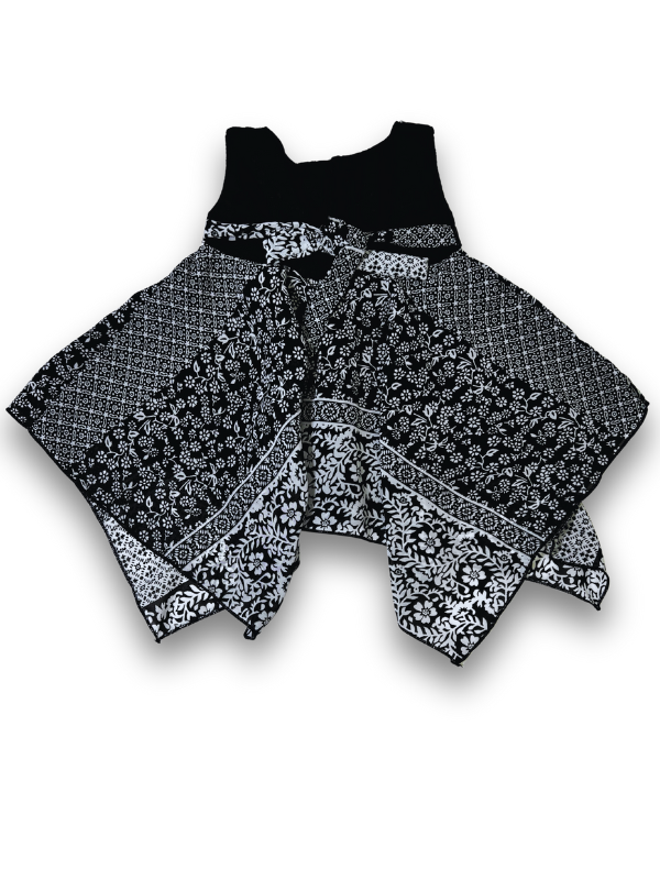 Black and white patterned girls' handkerchief hem frock with a black velvet-look bow and pearl trim on a white background.

Export to Sheets