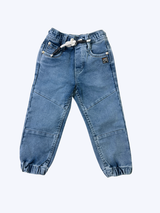 Boys' cream/light beige cargo pants with an elastic waist, green drawstring, and large flap cargo pockets.