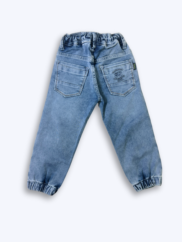 Boys' cream/light beige cargo pants with an elastic waist, green drawstring, and large flap cargo pockets.