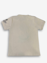 Off-white/cream boys' short-sleeve T-shirt with a light blue and gray brushstroke texture, featuring the word "MOUNTAIN" in a pink/purple gradient and a motivational quote below