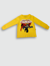 Mustard yellow boys' short-sleeve T-shirt with a large dark brown floral/leaf print and a small circular 'Be Humble' emblem on the chest.