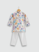Boys' full-sleeve cream/off-white kurta with an all-over multi-color abstract floral print in purple, blue, and orange, paired with solid white straight-fit pajama bottoms. The ethnic set is shown hanging on a wooden hanger