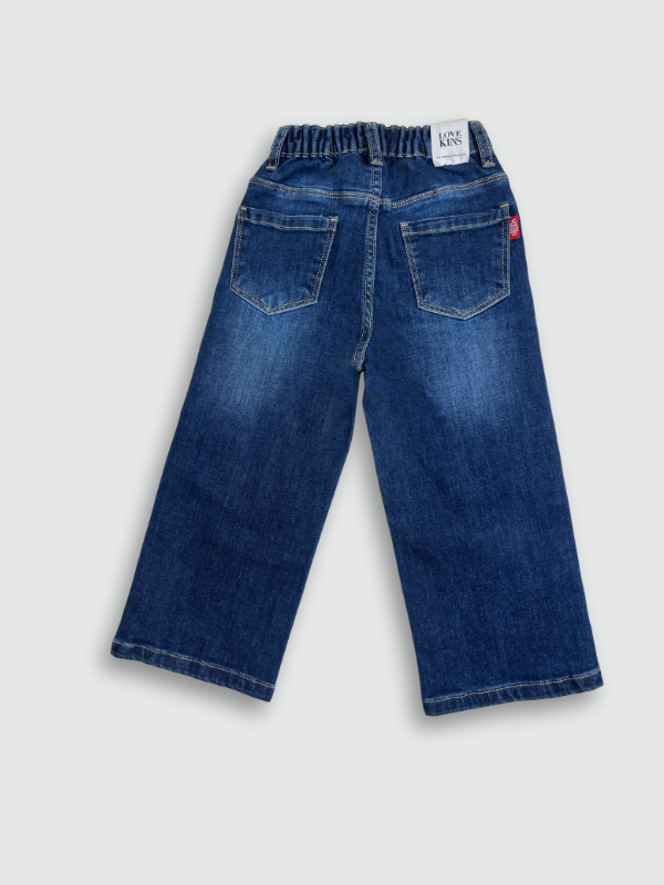 Dark blue wash children's wide-leg denim jeans with large square cartoon character patches (including Road Runner and Bugs Bunny) on the front of the legs