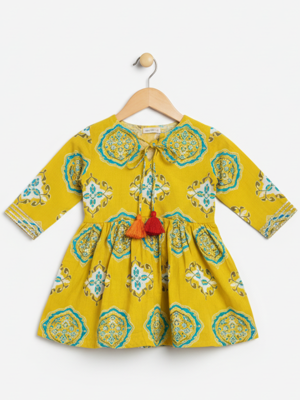 Full-length image of a young girl wearing a lime green and white floral-printed ethnic set with an embroidered peplum kurta, tiered sharara pants with a zig-zag print, and a white and green dupatta.