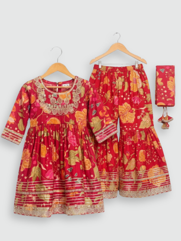 Full set laid flat: a vibrant red, gold-printed kurta with gold embroidered neckline, and matching tiered sharara pants with gold lace detailing.