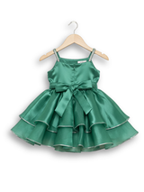 Teal green girls' sleeveless party frock on a hanger, featuring a shimmering pleated skirt and two large flower appliqués made from gold cord on the bodice.