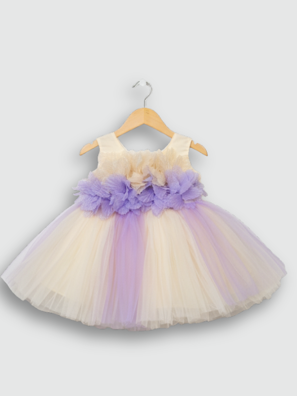 Cream girls' sleeveless party frock on a hanger, featuring a 3D flower-embellished bodice in cream and purple, and a full, layered tulle skirt with vertical lavender strips.