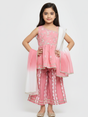 Full-length image of a young girl wearing a powder pink ethnic set with an embroidered sleeveless peplum top, tiered gharara pants with a geometric print, and a pink-to-white ombre dupatta.