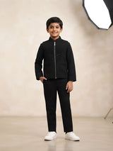 Boy wearing a sleek black embellished zip-front jacket with matching pants
