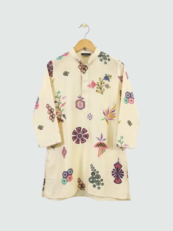 Boys' cream colored kurta with colorful all-over print of geometric and floral motifs, hanging on a wooden hanger.