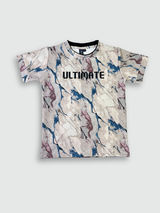Boys' short-sleeve T-shirt featuring a cream, blue, and maroon marble-like print with the black text 'ULTIMATE' across the chest.